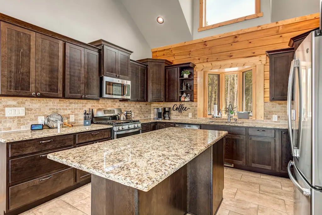 The oversized gourmet kitchen is comfortable to handle several chefs at once and is open to the Great Room so that the entire group can stay engaged during the meal prep!
