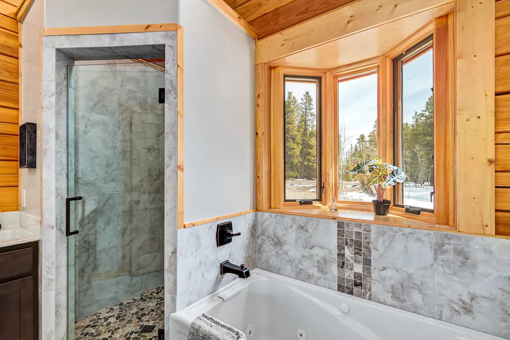 The SUMMER Suite has a large bathroom and features a walk-in shower, jetted soaking tub and double sinks.