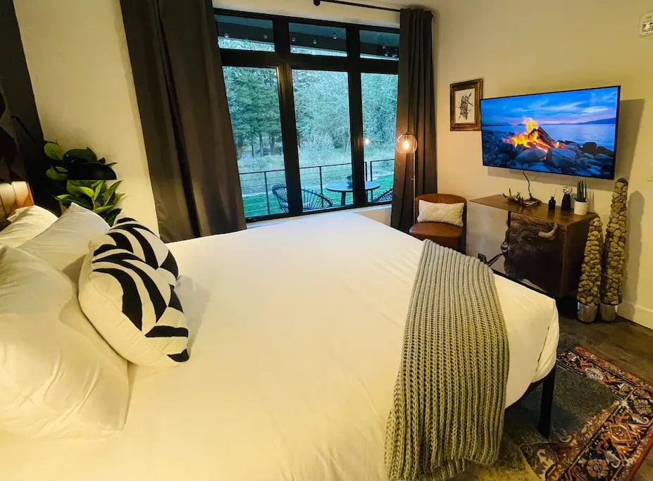 Enjoy the view from the King bedroom.   Open the sliding doors for some fresh mountain air and the soothing sounds of the  Blue River!