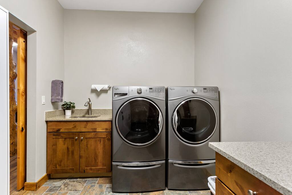 Full size washer and dryer in a large laundry room with laundry soap provided!
