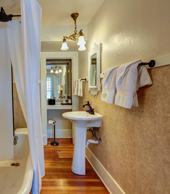 The ensuite bathroom for the Midland Room features one of 4 of the traditional clawfoot tubs found throughout the home.