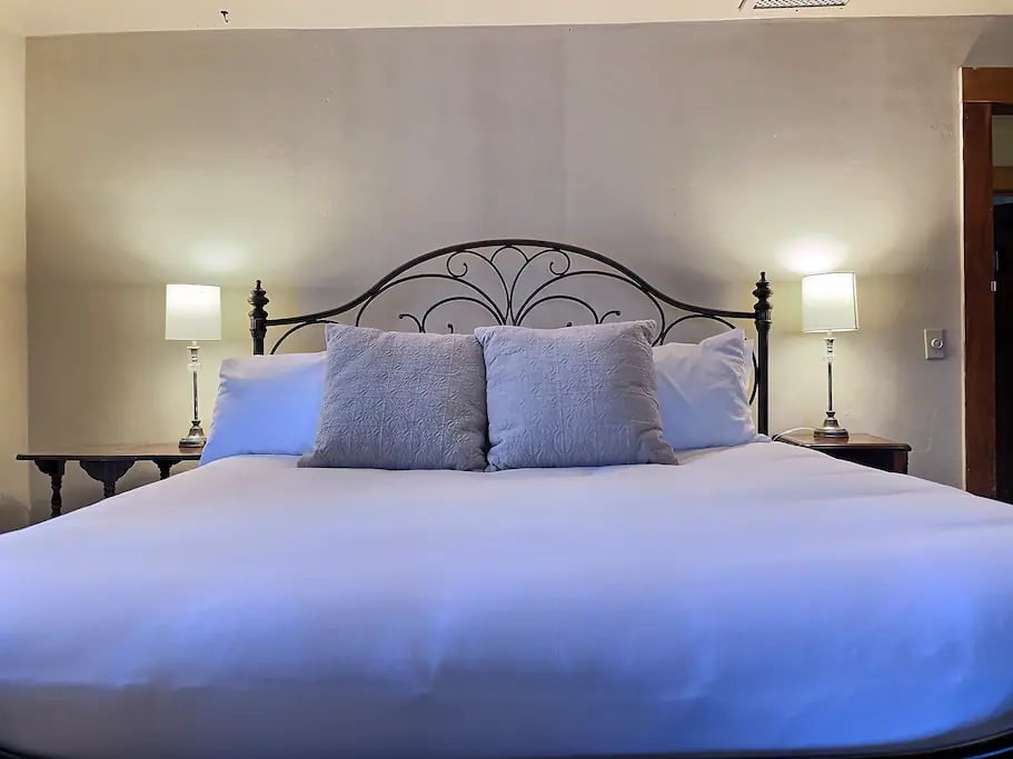 The Osage Room - A signature room at The Avenue.  Featuring a plush king-size bed with luxury linens and hotel quality pillows.
