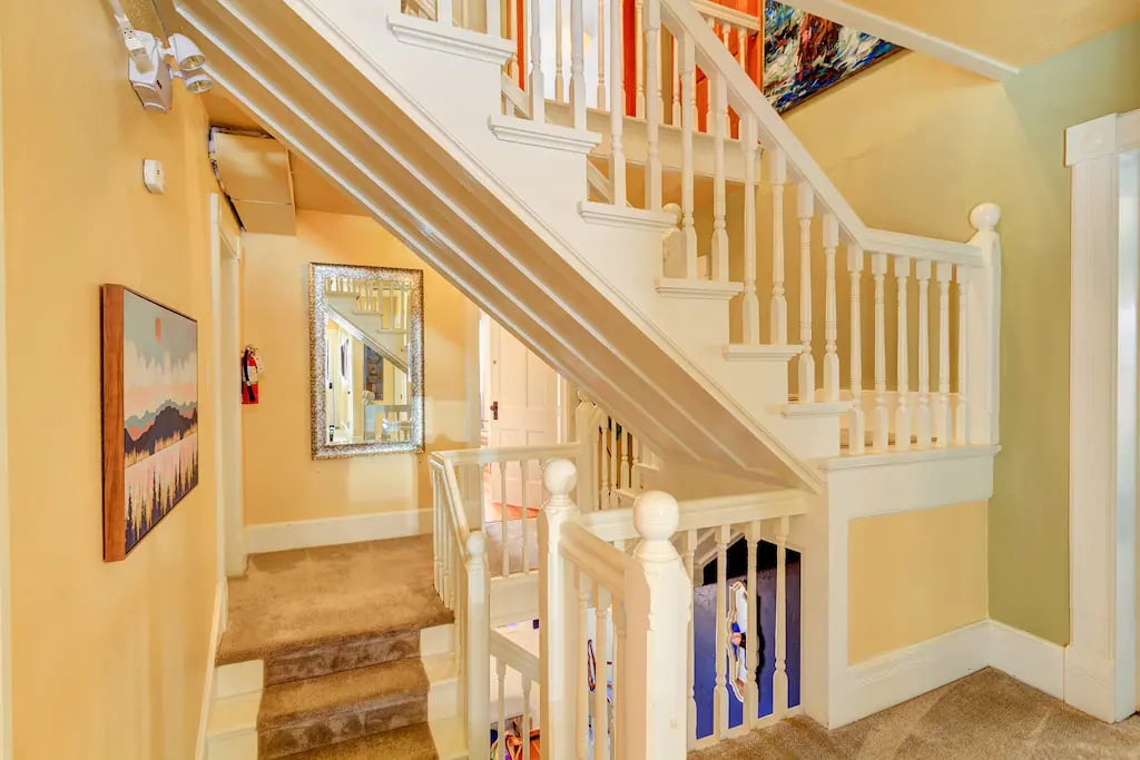 The three-story staircase is central to the home connecting all three levels of this historic mansion.