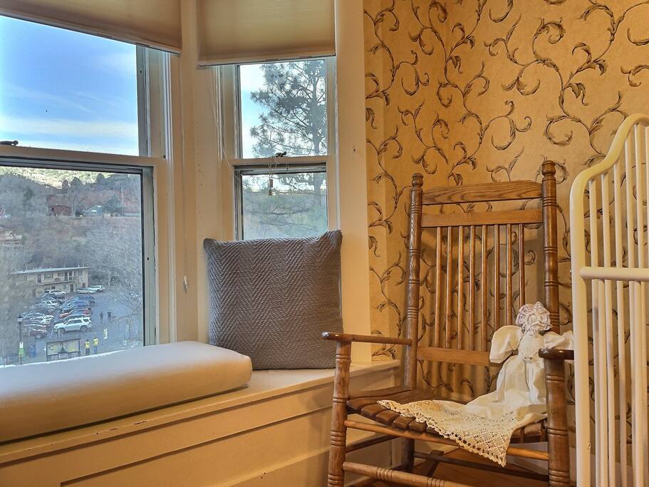 The shaker rocking chair sits next to the window perched above Manitou Avenue.
