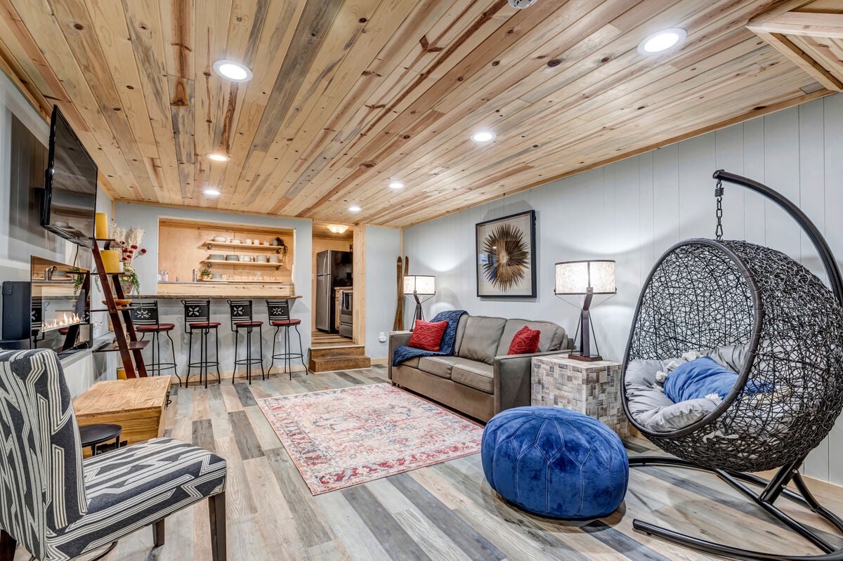 Fun space downstairs to hang and watch TV in this rec room that opens into a 2nd kitchen