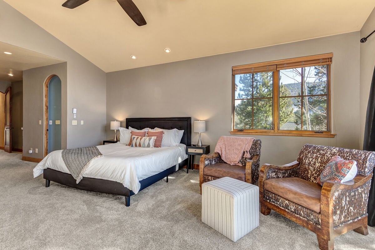 The master Suite is grand, featuring a private balcony and terracotta framed gas fireplace.
