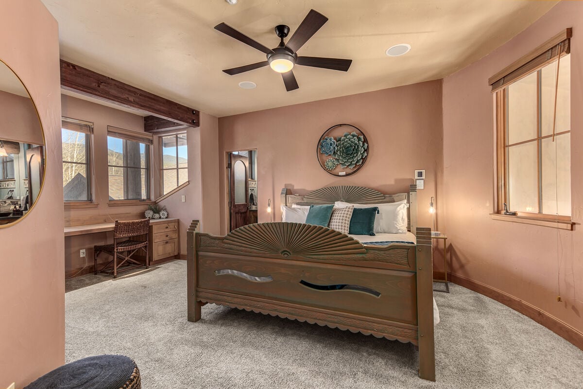 This expansive king master suite features a work station with a fabulous forest and gold course view.