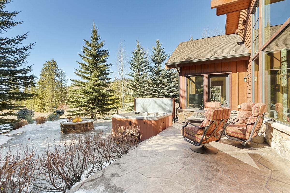 Large hot tub, fire pit, fire table and comfortable seating area on the back patio