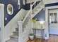 The beautiful winding staircase leads the way up the three story home.
