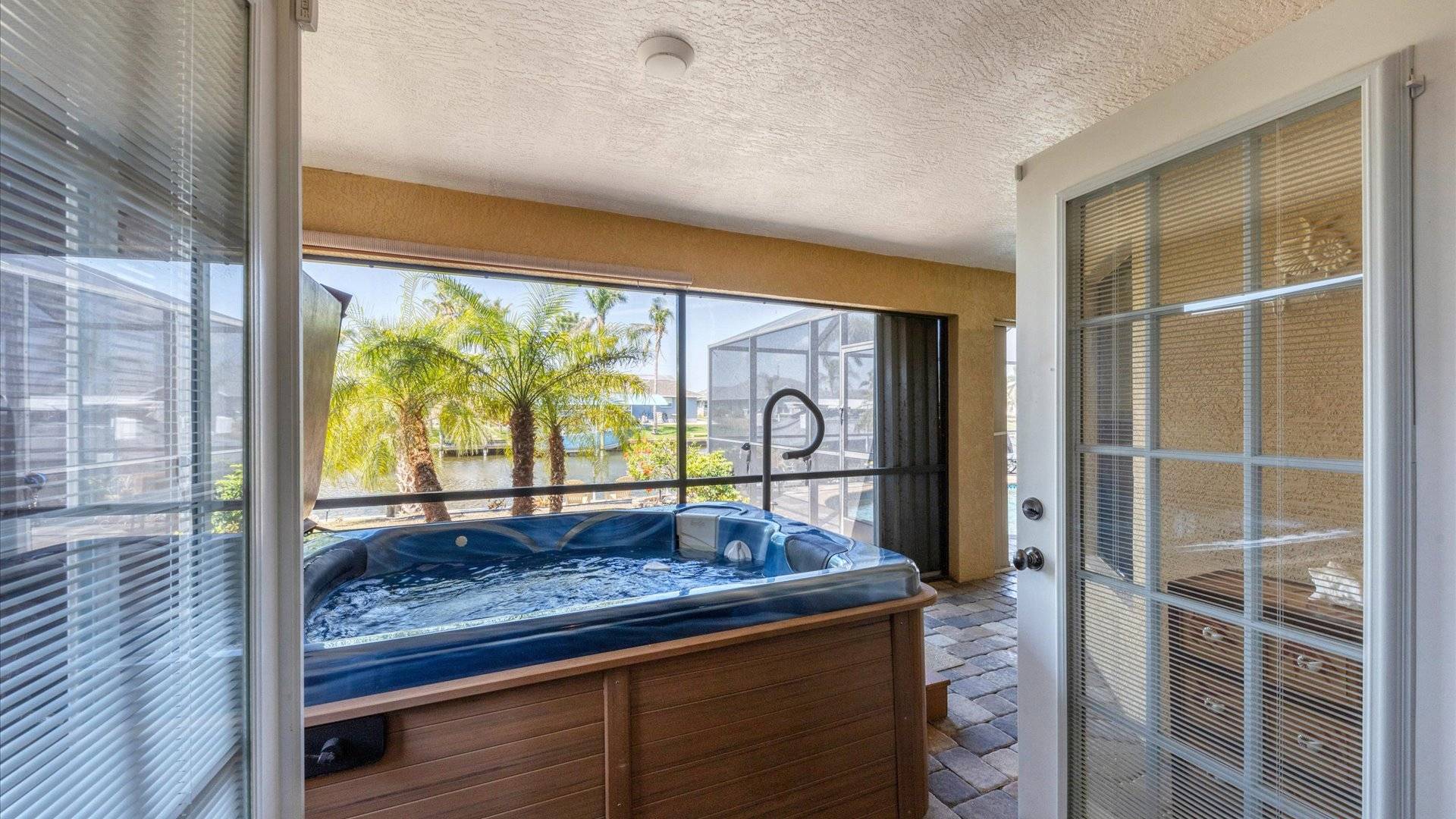 French doors open from master bedroom to lanai and stand-alone hot tub