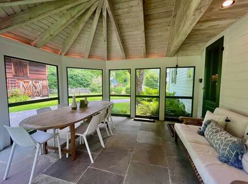 Screened porch is just off the kitchen with pool views