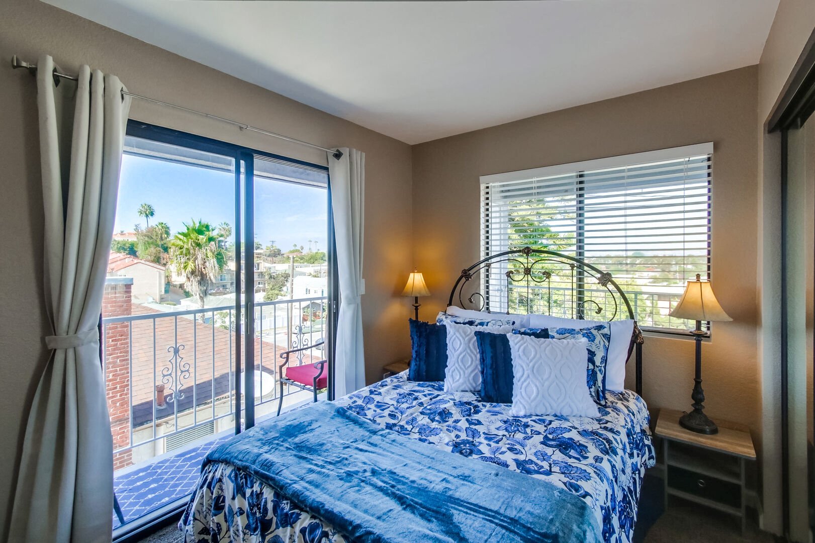 Guest bedroom with full size bed, private patio, ample natural light and closet and dresser storage