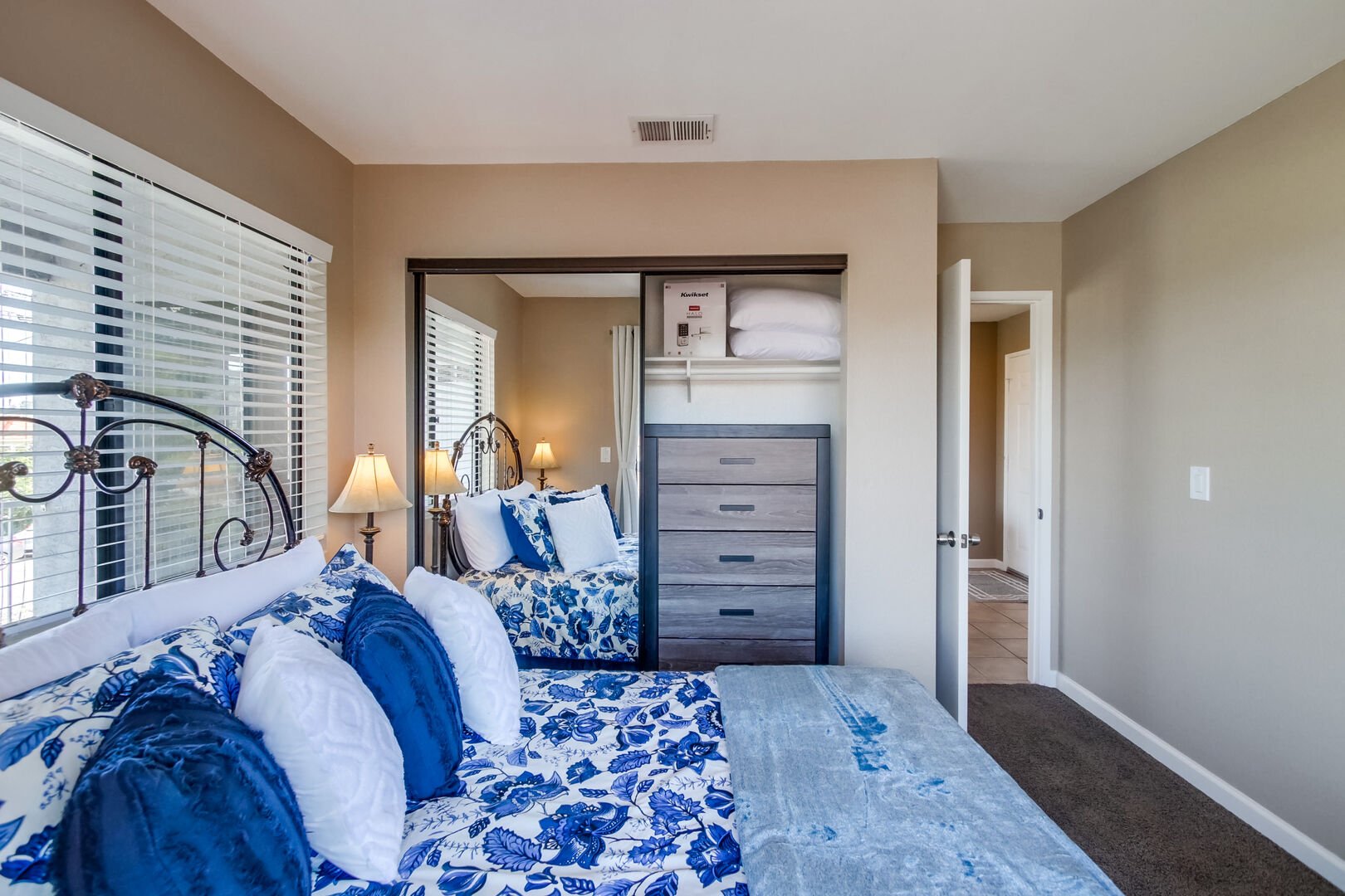 Guest bedroom with full size bed, closet and dresser and views to the west and north with plenty of natural light!