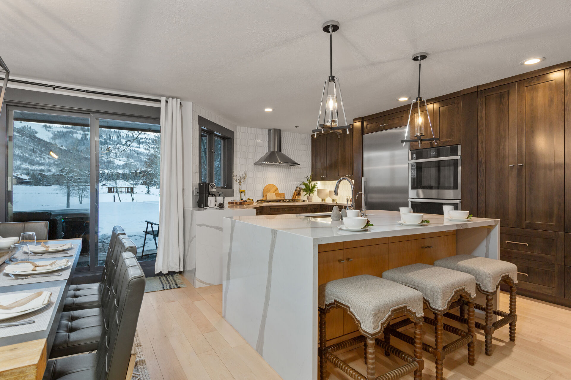 Fully Equipped Kitchen with stainless steel appliances, gorgeous stone countertops, and island seating for three