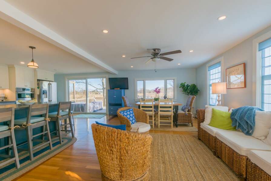 Open concept living room into dining area with flat screen TV.