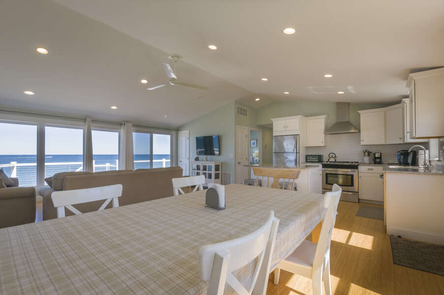 Large dining room table with access to the kitchen.