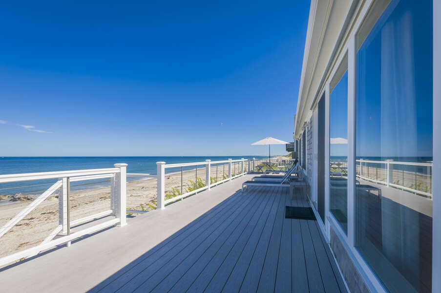 Back deck over looking a long stretch of beach for guest access.