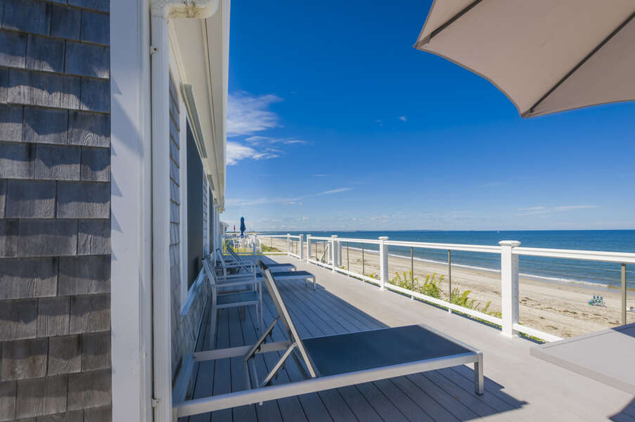 Back deck with ocean views, beach lounge chairs and an umbrella.