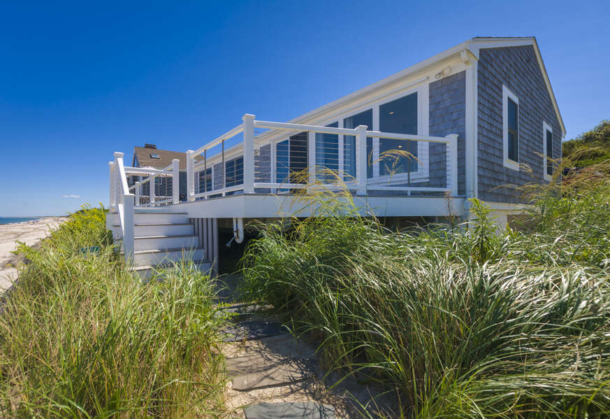 Large back deck with stairs leading to beach stairs for access to the ocean.