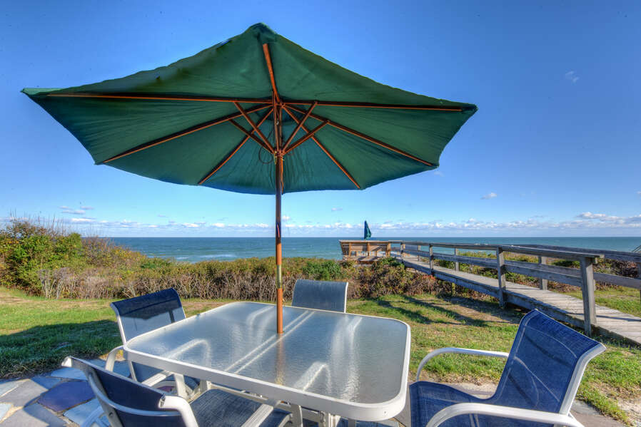 Outside patio furniture overlooking the ocean.