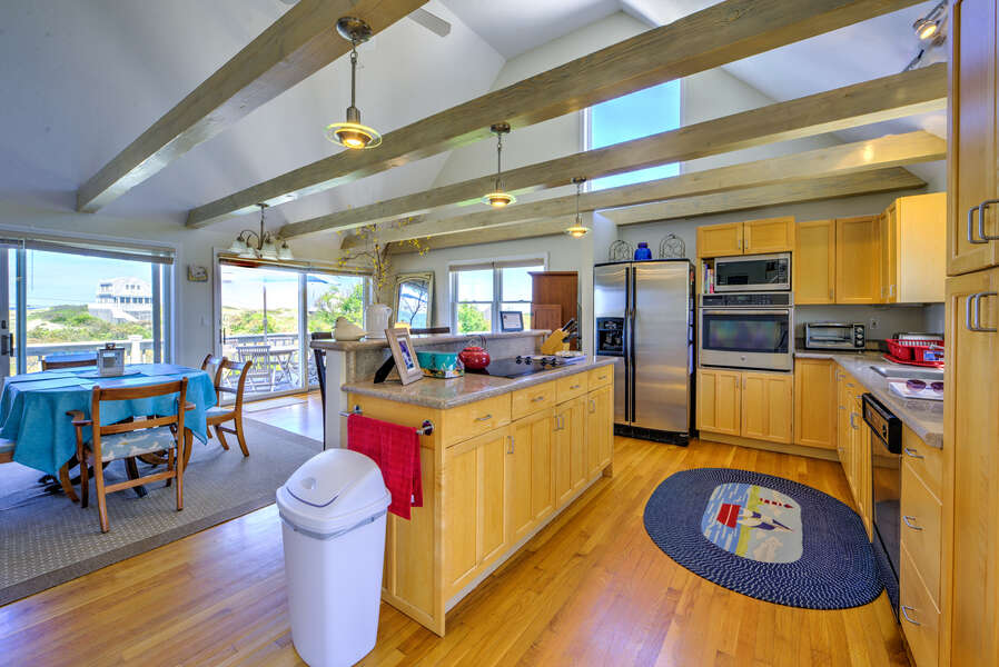 Large fully functioning kitchen with seating for two guests at the island.