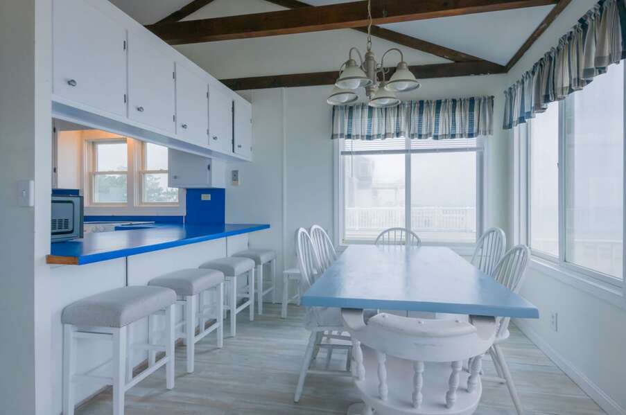Dining area with seating for six guests plus a breakfast bar with seating for four guests.