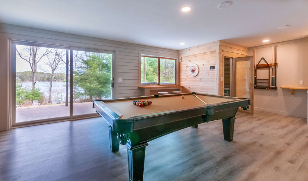 Lower Level Pool table and sauna with outdoor jacuzzi.