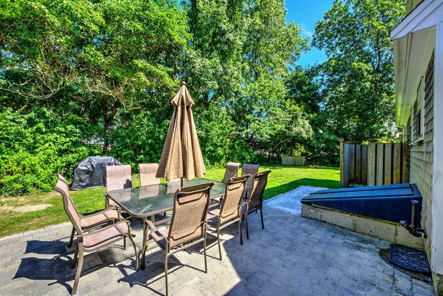 Outdoor patio with seating for 8 guests to enjoy the weather while grilling.