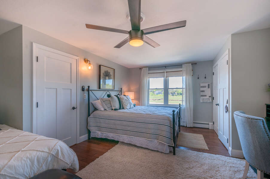 Bedroom 3 with ceiling fan and views from upper level.