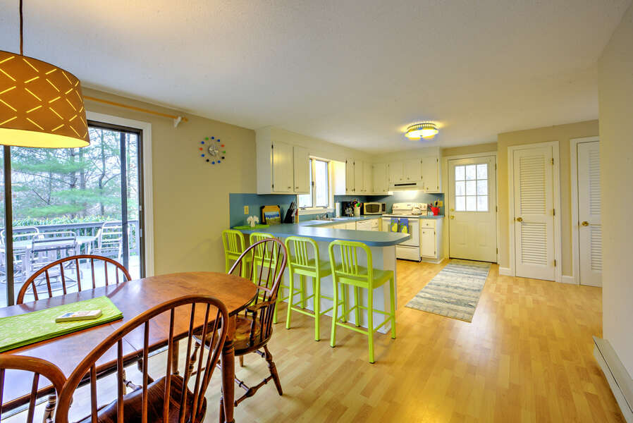 Open concept dining/kitchen area with seating for four guests at the breakfast bar.