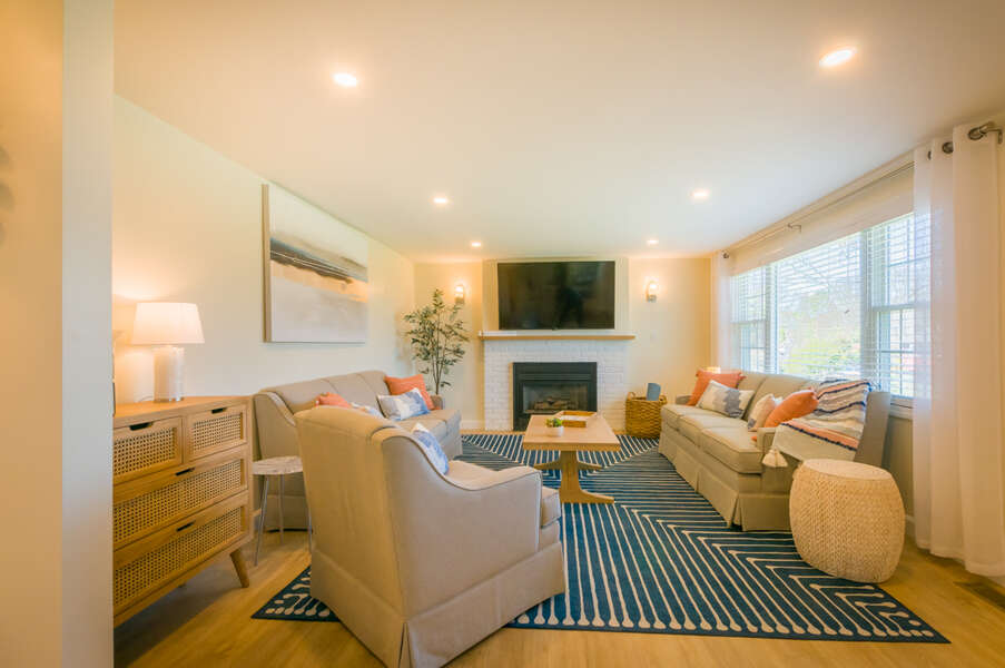 Living room with plenty of seating for the family by the working fireplace that is available to guests.