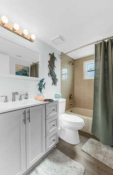 Guest bathroom with a tub/shower.