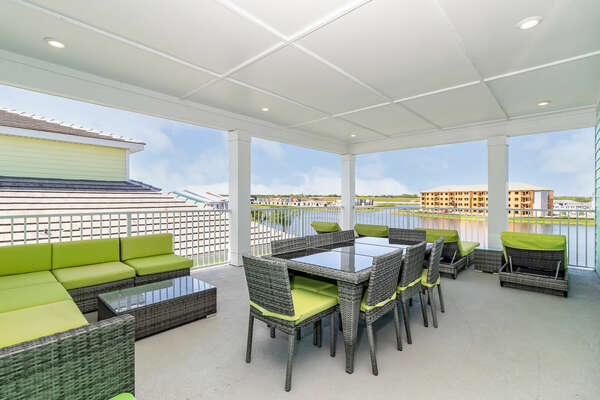 The third floor party deck is great for hanging out. A dining table for 8 and a sectional sofa.