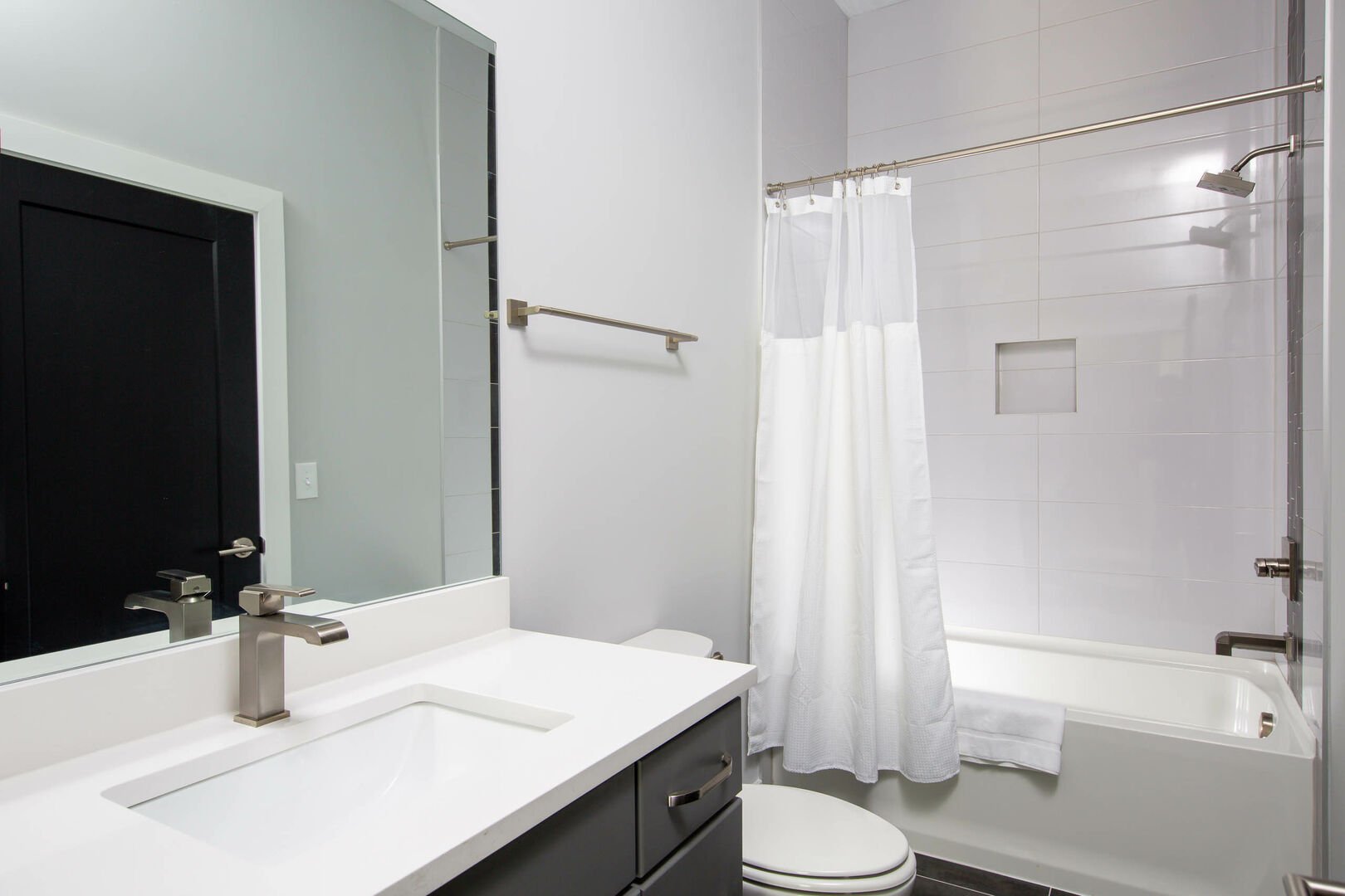 (1st Unit): 2nd bedroom attached bathroom with shower/tub combo