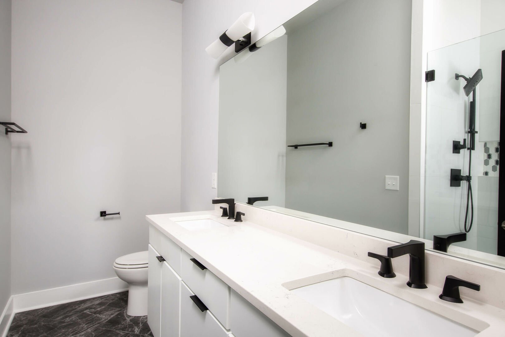 (1st Unit): Master bathroom with double sink vanity and large walk-in shower