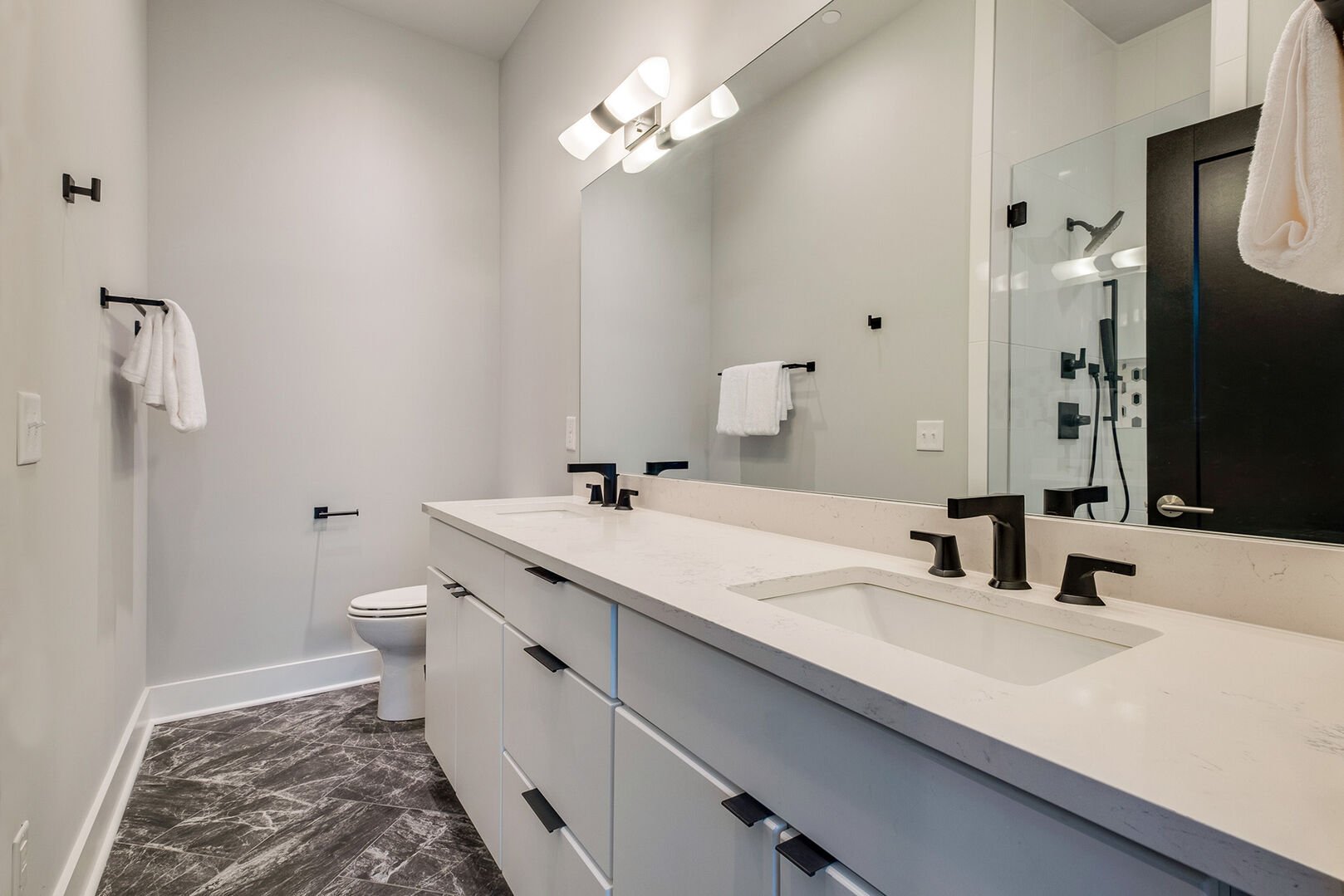Master bathroom with double sink vanity and large stand up shower