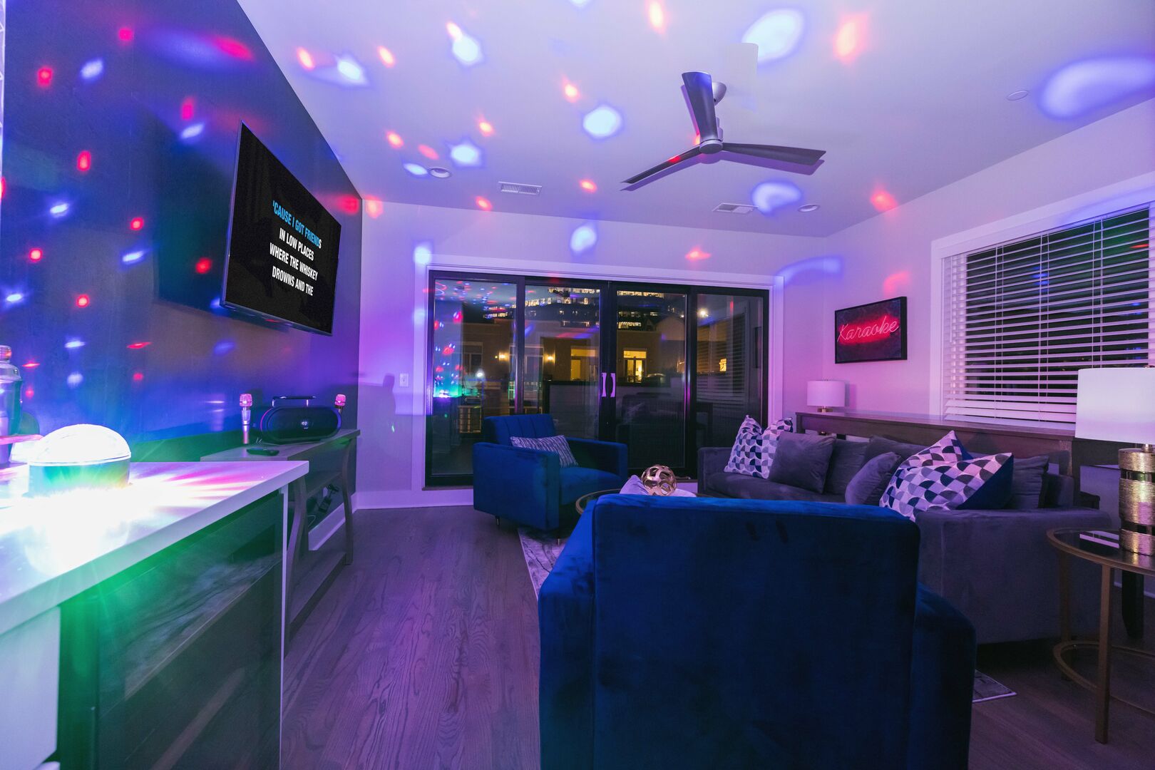 Top floor living space with wet bar, smart TV, karaoke, colorful light display, and access to rooftop patio!
