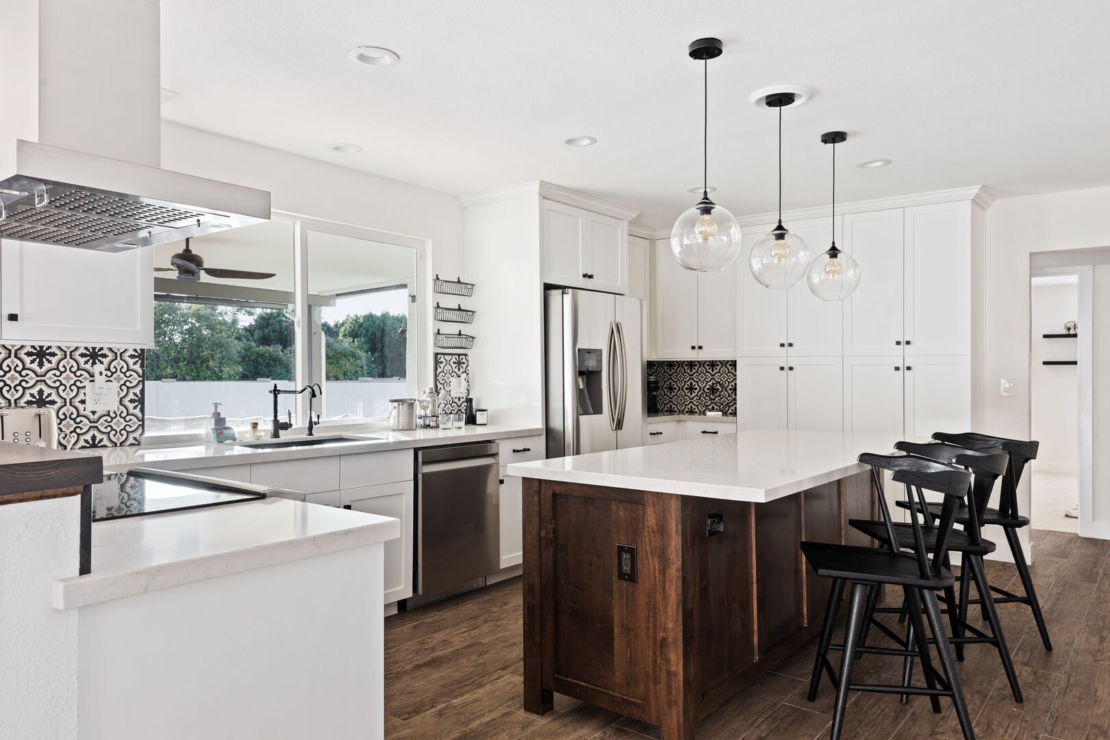 Stainless steel appliances and seating at the kitchen island for three.