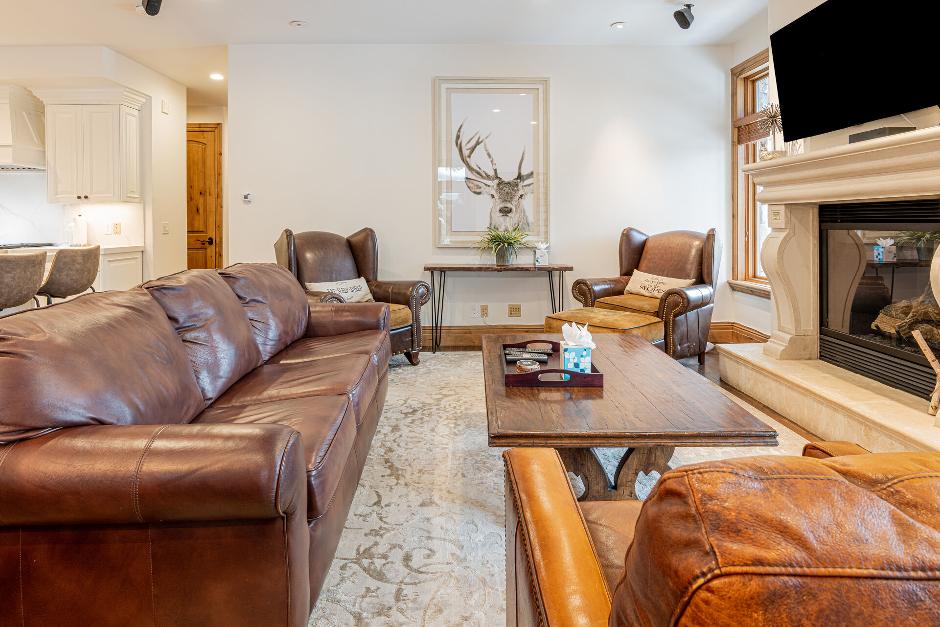 Living Room with plush leather sleeper sofa, Smart TV, and a cozy gas fireplace