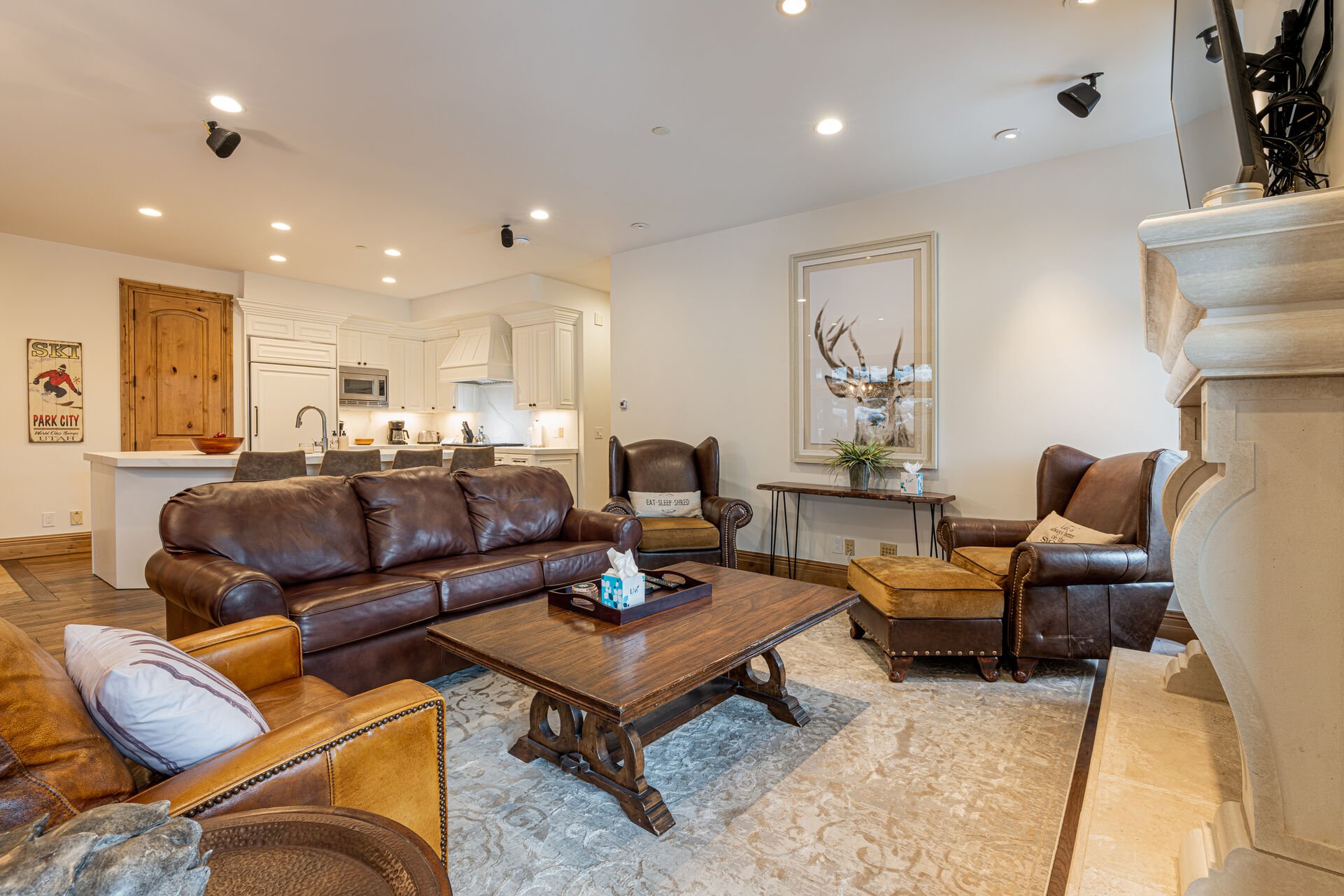 Living Room with plush leather sleeper sofa, Smart TV, and a cozy gas fireplace