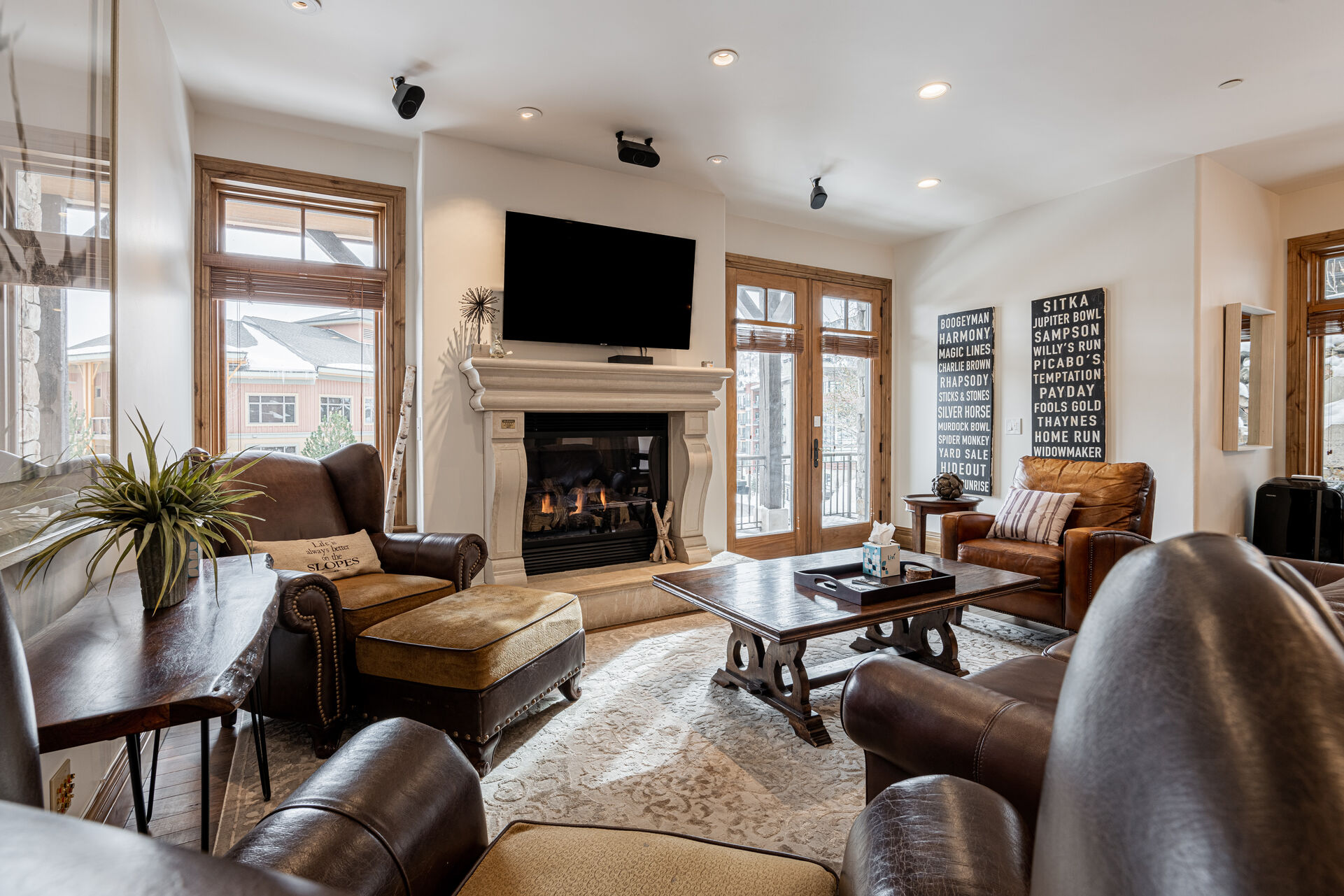 Living Room with plush leather sleeper sofa, Smart TV, and a cozy gas fireplace