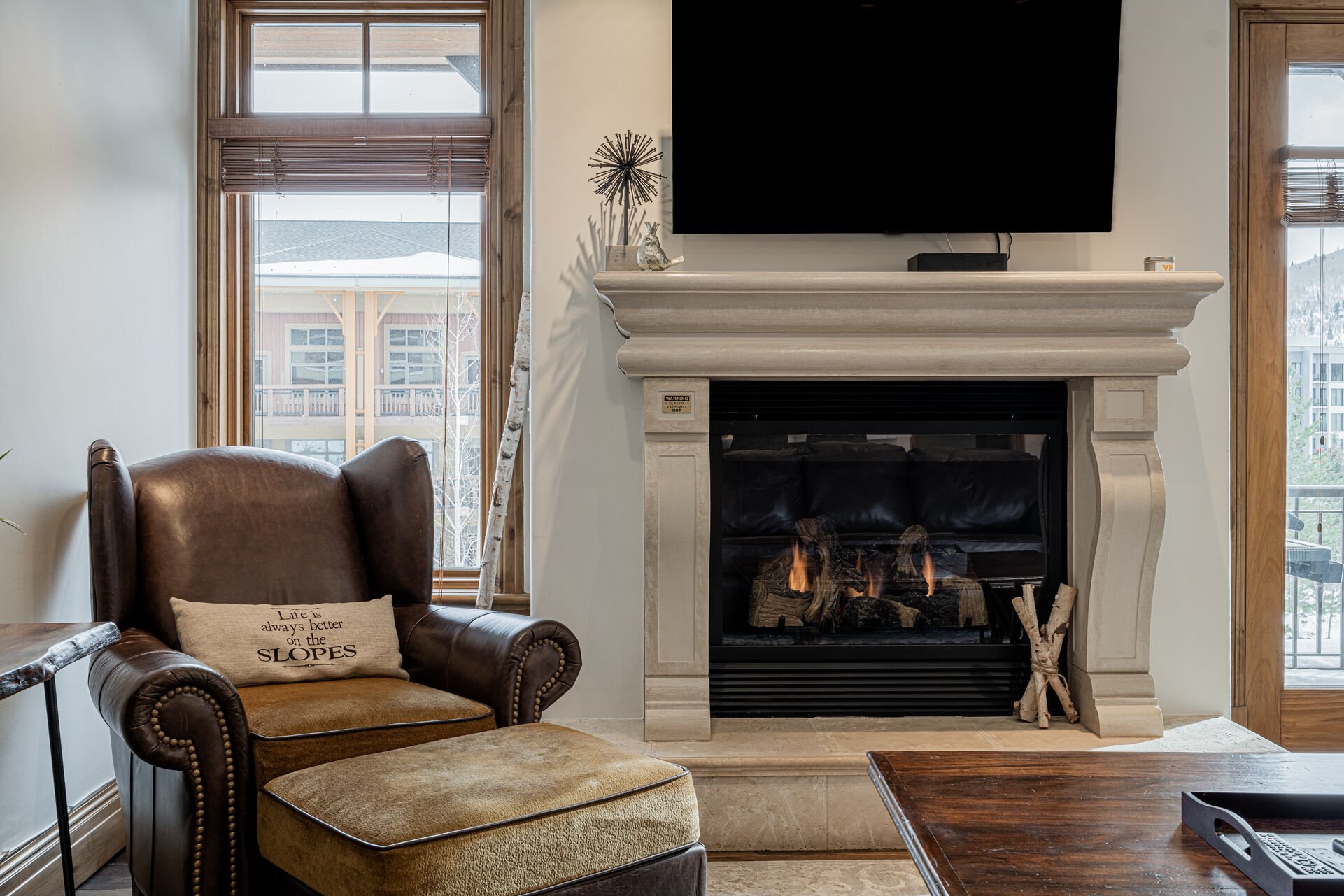 Living Room with plush leather sleeper sofa, Smart TV, and a cozy gas fireplace