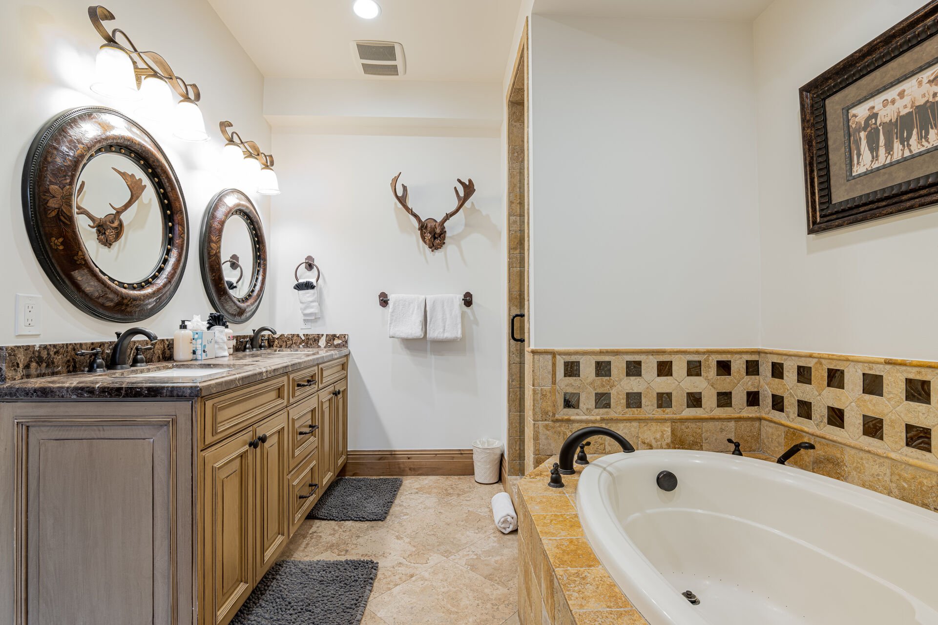 Master bath with dual sinks, a jetted tub, and separate shower