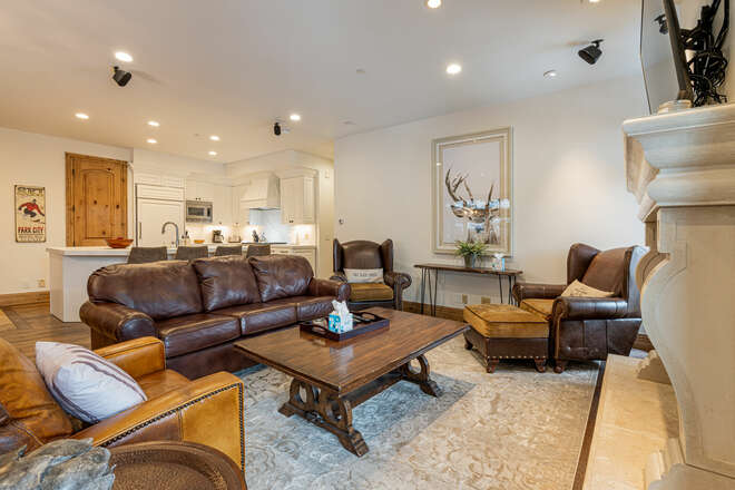 Living Room with plush leather sleeper sofa, Smart TV, and a cozy gas fireplace