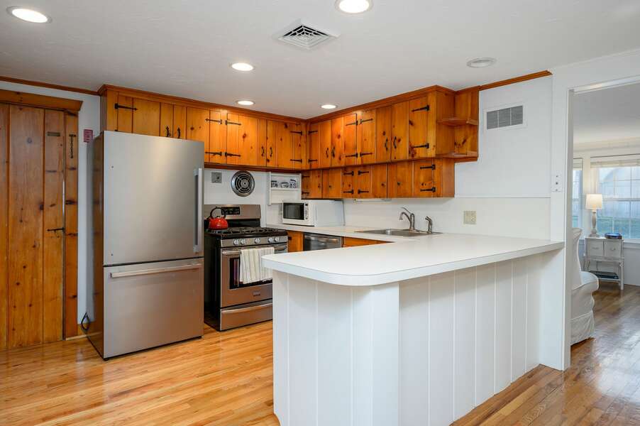 Classic kitchen with stainless steel appliances, beachy wood cabinets and white countertops - 3 Shore Road Extension West Harwich Cape Cod - A Shore Thing - New England Vacation Rentals