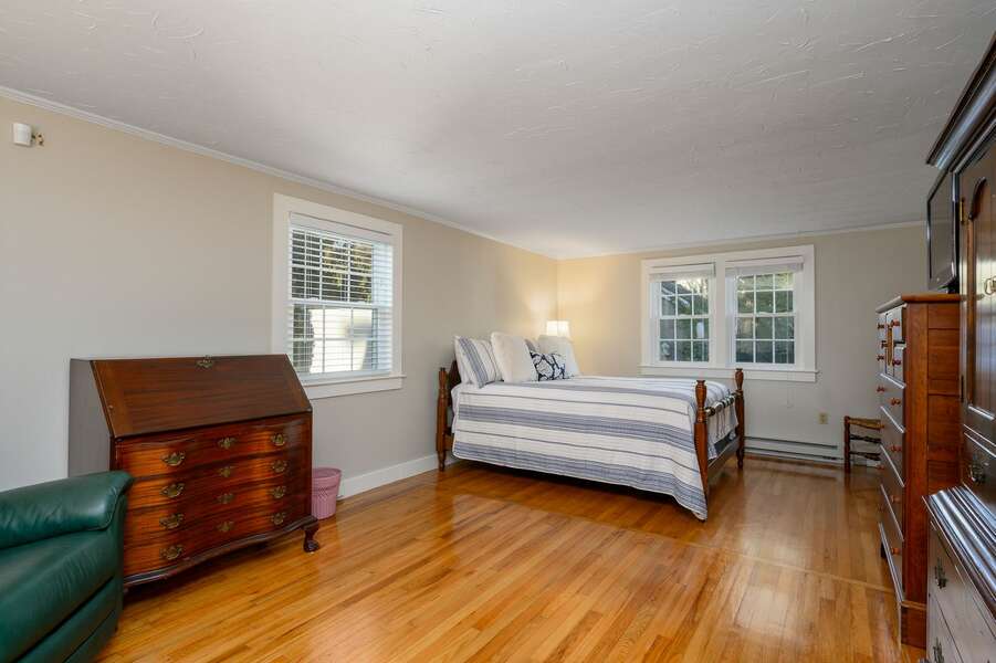 Spacious primary bedroom with stately furniture and a Queen sized bed - 3 Shore Road Extension West Harwich Cape Cod - A Shore Thing - New England Vacation Rentals
