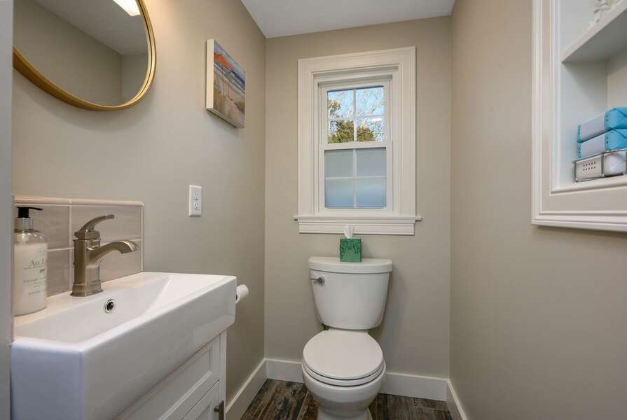 Half bath conveniently located where the hall begins off of the dining and living spaces - 3 Shore Road Extension West Harwich Cape Cod - A Shore Thing - New England Vacation Rentals