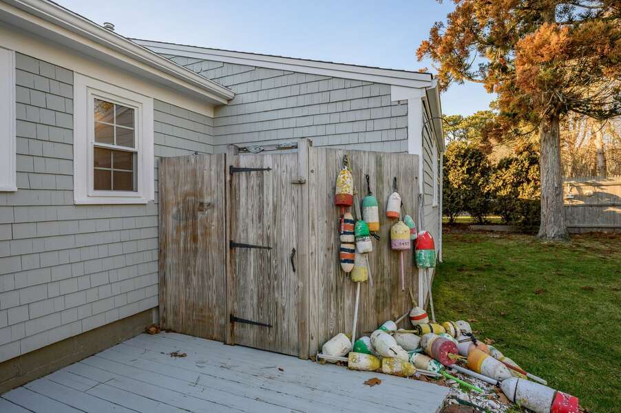 Classic outdoor shower with brightly colored whimsical Cape buoys - 3 Shore Road Extension West Harwich Cape Cod - A Shore Thing - New England Vacation Rentals