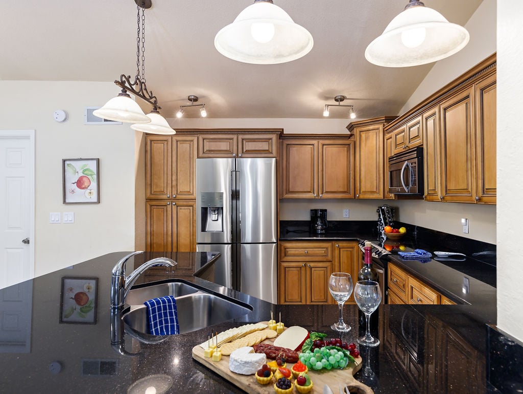 Open concept kitchen fully stocked with your basic cooking essentials, stainless steel appliances, breakfast bar seating, and breakfast table.