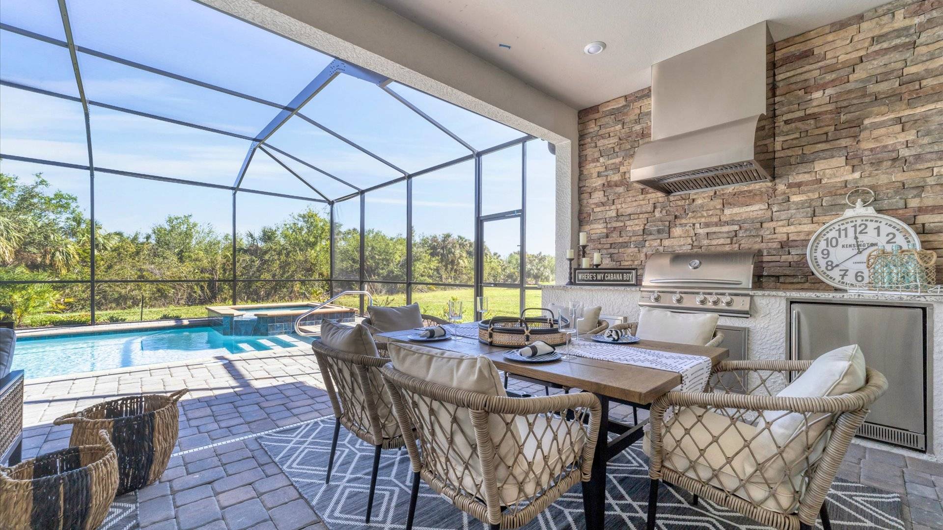 Gorgeous lanai with dining table, outdoor kitchen, pool and spa